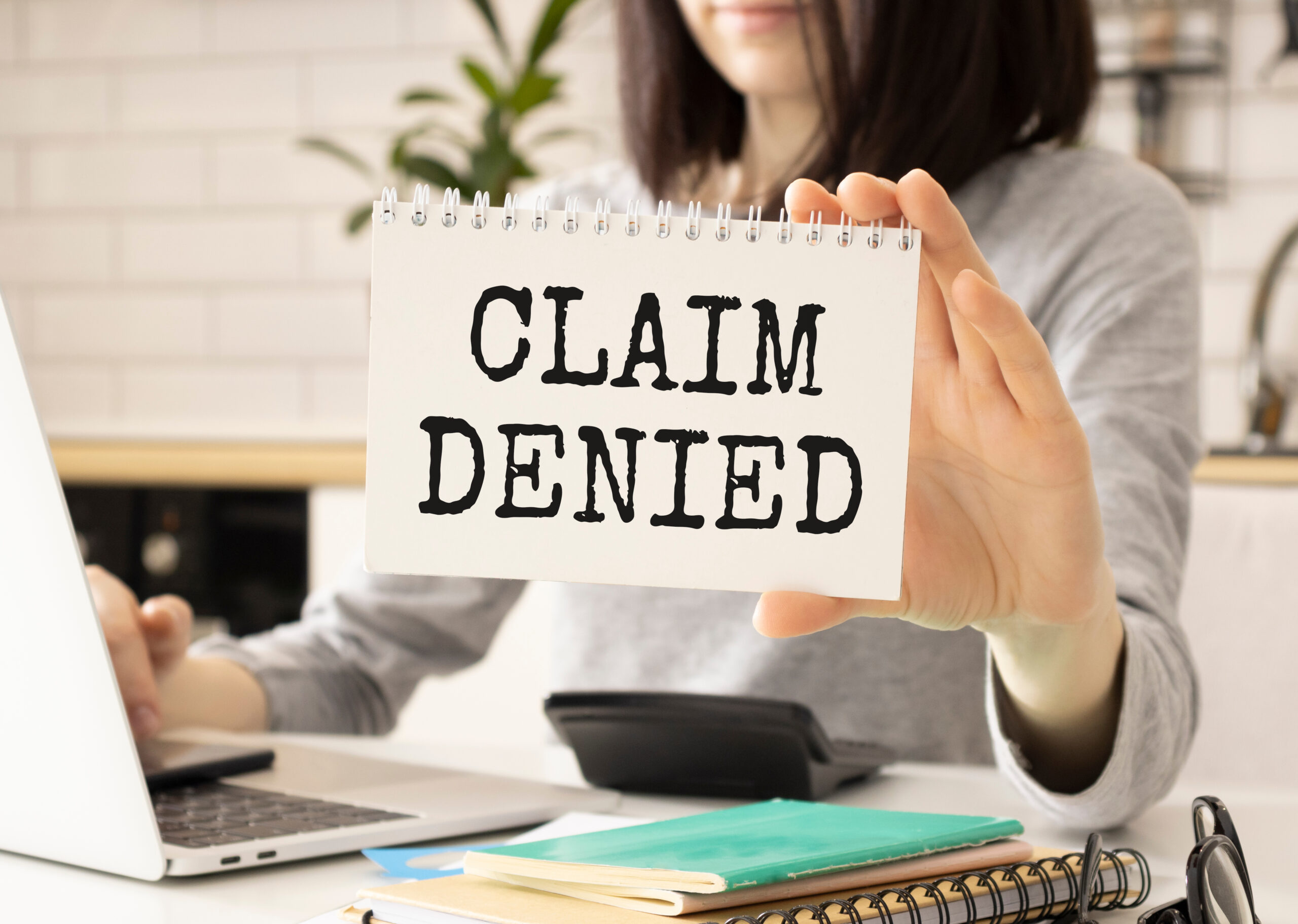 Business,Woman,Shows,A,Card,With,Text,Claim,Denied,. Insurance Claim Denial